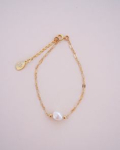 "The Delaney Pearl Bracelet features a beautiful gold-filled specialty link chain with a 1\" attached extender, making it easily adjustable to fit any wrist size. It is handcrafted with care and attention to detail, ensuring the highest quality and durability. The freshwater pearl with bead accents is hand wire-wrapped onto the chain, adding a touch of elegance and sophistication to this dainty gold bracelet. The Delaney Pearl Bracelet is the perfect complement to the other pieces in the Delaney Luxury Dainty Pearl Bracelets, Dainty Gold-plated Oyster Bracelet, Dainty Gold Plated Oyster Bracelet, Elegant 14k Gold Filled Bracelet With Extender, Gold Oyster Bracelet Jewelry For Wedding, Gold Dainty Charm Bracelet With Extender, 14k Gold-filled Pearl Charm Bracelet, Delicate Gold Chain Bracelet With Pearl Charm, 14k Gold Filled Pearl Charm Bracelet