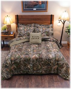 a bed covered in camo comforter and pillows with the words black river on it