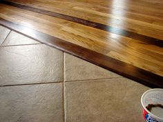 a can of ice cream sitting on top of a wooden floor next to a counter