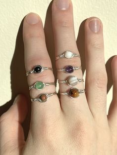 Mini Minimalist Wire Wrapped Ring :) These rings are made out of premium quality TARNISH RESISTANT 24 gauge silver and gold plated wire Your choice of 2 mm or 3 mm round gemstones. Options include: - Amethyst (2 mm) - Moonstone (2 mm) - Green Aventurine (2 mm) - Tigers Eye (3 mm) - Freshwater pearl - synthetic (3 mm) - Hematite (2 mm) - Unakite (2 mm) ✤ Care ✤ Due to the structure of natural gemstones (some are more porous, softer etc.) it is best to keep away from water, soaps, perfume, lotions Adjustable Simple Design Midi Rings With Round Band, Adjustable Simple Design Midi Rings, Handmade Adjustable Minimalist Birthstone Ring, Dainty Metal Stackable Rings, Handmade Minimalist Adjustable Birthstone Ring, Minimalist Metal Crystal Ring For Gift, Adjustable Hypoallergenic Midi Rings, Minimalist Crystal And Metal Ring As A Gift, Simple Adjustable Hypoallergenic Stackable Rings