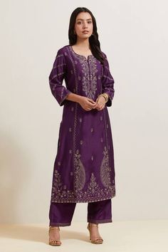 Purple natural weaves chanderi silk kurta with contrast paisley and floral embroidery. Comes with pant and shimmer organza dupatta.
Components: 3
Pattern: Embroidered
Type Of Work: Floral and Paisley
Neckline: Notched
Sleeve Type: Three Quarter
Fabric: Chanderi Silk, Shimmer Organza
Color: Purple
Other Details: 
Embroidered hem pant
Fringed border dupatta
Occasion: Puja - Aza Fashions Purple Tunic, Natural Weave, Silk Kurta, Indian Heritage, How To Hem Pants, Organza Dupatta, Kurta With Pants, Kurta Set, Womens Tunics