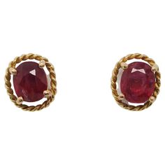 This is a beautiful pair of mid-century stud earrings in 14k yellow gold featuring bright red ruby centers! The rubies are a classic oval shape in a four-prong setting that is surrounded by a twist wire frame with an element of negative space between. The oval shape of the earrings can be worn vertically or horizontally for a subtle change in the look! The rubies have an excellent rich red color that is complemented perfectly by the yellow gold. These are the perfect earrings for the woman who l Ruby Stud Earrings, Gold Ideas, Vintage Gold Earrings, Ruby Earrings Studs, Gold Diamond Earrings Studs, Gold Diamond Studs, Gold Necklace Indian, Gold Necklace Indian Bridal Jewelry, Indian Bridal Jewelry