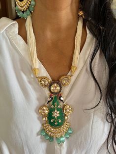 New Arrival ♥️ All our pieces are in stock and will be dispatched with in 24 to 48 hours of order. Orders received during the weekend will be dispatched on Monday.  Beautiful carved stone at the center adds perfect glamour. One of our favorite picks for the wedding season ❤️ Materials: Siver, Gold, Brass, Copper, Jade Stone, Mini Pearls, Kundan Work Dimensions Weight of the necklace: 110 grams Drop Length of the necklace: 10.5 inches Height of pendant: 5.5 inches Width of pendant: 3 inches Weight of earrings is 60 g per pair. (Heavier Side) Length of earrings: 9 cms. Width of earrings: 6 cms. Push back closure/ Omega Clip at the back. Necklace has hook closure and is adjustable. Fusion Style Bridal Necklace With Meenakari For Ceremonies, Fusion Style Ceremonial Bridal Necklace With Meenakari, Fusion Style Meenakari Bridal Necklace For Ceremonies, Fusion Style Bridal Necklace With Cutdana For Ceremonial Occasions, Handmade Kundan Bridal Necklace, Handmade Pendant Jewelry Sets For Wedding, Handmade Kundan Necklace For Wedding In Temple Style, Handmade Kundan Bridal Necklace For Ceremonial Occasion, Temple Jewelry Pendant For Wedding