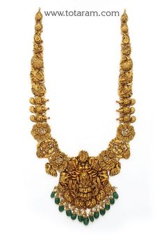 22 Karat Gold "Lakshmi - Peacock" Long Necklace with Beads & Pearls (Temple Jewellery)  Enhance Your Beauty with 22 Karat Gold "Lakshmi - Peacock" Long Necklace  This exquisite piece of temple jewelry is a symbol of elegance and tradition. Made in India by skilled artisans, this 22 Karat gold necklace is a timeless treasure that will add a touch of sophistication to any outfit. The intricate design featuring Lakshmi and peacock motifs, along with beads and pearls, exudes luxury and grace. The ne Long Temple Jewellery, Long Temple Jewellery Necklace, Long Chains Indian Gold Traditional, Gold Long Necklace With Grams, Gold Temple Jewellery Necklace Set, Lakshmi Necklace Gold, Gold Long Chains Indian Jewellery, Long Gold Chain Designs For Women, Long Necklace Gold Indian Bridal