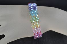 Crystal, crystal bracelet, women's cuff, rainbow, fashion accessory, luxury, chakra For good vibes, harmonious colors Width : 1.5 cm Length: 18.5 cm or other Clasp 3 rows rhinestone Crystal 13 mm plated rhodium You can ask me the length that you wish in order to adapt it perfectly to your wrist.  Material: crystal, rocailles, clasp in rodhium guaranteed without nickel Crystal is glass with a refractive index of 1.545 or higher. Unlike glass, crystal has more clarity, more brightness. Multicolor Crystal Bracelet Jewelry, Rainbow Bangle Bracelets For Party, Rainbow Bangle Bracelet For Parties, Rainbow Bangle Bracelet For Party, Multicolor Crystal Round Bracelets, Multicolor Crystal Bracelets With Round Beads, Multicolor Round Crystal Bracelet, Multicolor Crystal Bracelets For Gifts, Multicolor Crystal Jewelry With Jubilee Bracelet