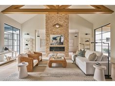 a living room filled with furniture and windows