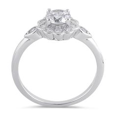 Top of Ring Height: 9.0mm

Top of Ring Width: 9.0mm

Band Width: 1.9mm

Shank Width: 1.6mm



Stone material: Clear Cubic Zirconia

Center stone size: 5.5mm

Stone shape: Round

Center stone carat weight: 0.66 ct.

Total number of CZ stones: 13

Stone setting: Prong



Metal: 925 Sterling Silver

Plating: Rhodium Plated

Finish: High Polish White Gold Flower Shape Ring With Brilliant Cut, White Gold Brilliant Cut Ring In Flower Shape, Cubic Zirconia Flower Ring With Diamond Accents, Flower Ring With Diamond Accents And Cubic Zirconia, Classic Diamond Ring With Flower Shape, Elegant Flower Shaped Cluster Promise Ring, Elegant Flower-shaped Promise Ring, Classic Crystal Ring With Halo Design In Cubic Zirconia, Classic Cubic Zirconia Crystal Ring With Halo Design