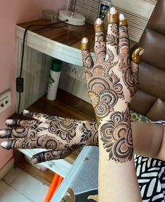 a woman's hand with henna on it