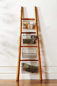 A decorative accent for your bedroom or living space, this teak ladder rests against the wall to provide light storage for blankets, prized wardrobe pieces, and linens. | Travis Decorative Teak Blanket Ladder by Anthropologie in Beige, Linen Wooden Ladder Decor Living Room, Interior Ladder Decor, Throw Ladder Blanket Holder, Ladder Room Decor, Townhome Entryway Decor, Styling Blanket Ladders, Ladder In Bathroom Decor, Blanket Ladder With Plants, Ladder In Kitchen