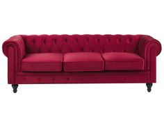 a red couch sitting on top of a white floor