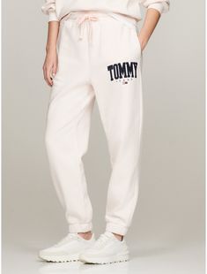 Tommy Hilfiger women's pant. Made from soft, brushed-back fleece with a clean, contemporary face and modern feel, our sweatpants are finished with a varsity-inspired Tommy logo. Part of our Tommy Jeans collection.  Material: 70% Cotton, 30% Polyester. Sporty Logo Print Bottoms For Loungewear, Athleisure Bottoms With Logo Print, Athleisure Bottoms With Logo Print For Loungewear, Sporty Loungewear Bottoms With Logo Print, Athleisure Bottoms For Loungewear With Logo Print, Sporty Relaxed Fit Pants With Logo Print, Sporty Sweats With Embroidered Logo And Relaxed Fit, Sporty Logo Print Joggers For Loungewear, Athleisure Sweatpants With Logo For Loungewear