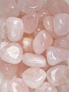 some pink rocks on a white surface