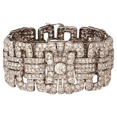 An Art Deco diamond bracelet. Set throughout with brilliant and circular-cut diamonds. The largest diamonds estimated to weigh 1ct each. Total diamond weight approximately 25cts. French marks. Circa 1935. 19cm in length and approximately 3.1cm wide. 99 grams. Set in platinum. Numbered "228" and with French marks. Price: 51,350£. Item is in very good condition without any damage. Return policy within 3 days is applied. Please make sure you watch the short video that gives real and accurate perspective of the item. Gold Link Bracelet, Antique Bracelets, Diamonds And Gold, French Art Deco, Art Deco Diamond, Antique Diamond, Vintage Designer, Short Video, Diamond Gemstone