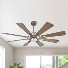 a ceiling fan with wooden blades in a living room