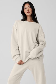 Chill Crew Neck Pullover - Bone | Alo Yoga Comfy Crew Sweatshirt With Ribbed Cuffs, Oversized Athleisure Sweatshirt With Soft Texture, Alo Yoga Sporty Sweatshirt With Ribbed Cuffs, Alo Yoga Sporty Relaxed Fit Sweatshirt, Alo Yoga Relaxed Fit Sporty Sweatshirt, Basic Crew Sweats For Loungewear, Basic Crew-neck Sweats For Loungewear, Basic Crew Neck Sweats For Loungewear, Comfy Sweats With Ribbed Cuffs