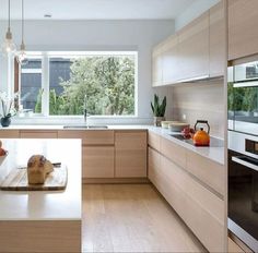 a kitchen with wooden cabinets and white counter tops, along with an island in the middle