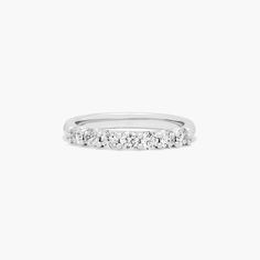 a white gold wedding band with five diamonds on the top and bottom, set in 18k white gold