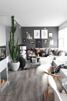 a living room filled with furniture and pictures on the wall