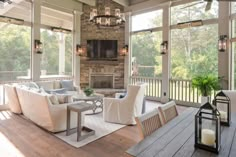 a living room filled with furniture and a fire place in the middle of an open floor plan