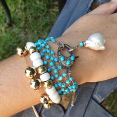 This feminine and elegant bracelet is a composition of turquoise chain, diamond and turquoise clasp and big white pearl and diamonds charm. You can wrap this bracelet around your wrist 3 times or even wear it as a necklace. Wear this bracelet by itself or layer with: https://www.etsy.com/listing/825660072/glass-bead-tie-bracelet-pony-bead?ref=shop_home_active_9&frs=1 You might also like: https://www.etsy.com/listing/513908525/turquoise-and-pave-diamonds-bracelet?ref=shop_home_active_6&fr Multistrand Bracelet, Chain Diamond, Multi Strand Bracelet, Opal Bracelet, Elegant Bracelet, Stackable Bracelets, Diamond Charm, Name Bracelet, Pony Beads