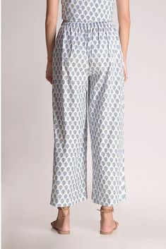 This white printed motif pant is a love story that blossoms sophistication with a tinge of charm. The relaxed fit of the pants gives a fresh look to the small motif prints on display. Mindfully crafted from cotton, it's like a superhero for the summer, ready to rescue you from sweat and stickiness. Rock this look with the Aster Printed Motif top & classy shoes or stilettos, and let the flower power spread its magic wherever you go! Material: CottonStyle/Print: Small Motif Handblock PrintPant Len Printed Relaxed Fit Spring Sleepwear, Blue Cotton Graphic Print Sleepwear, Floral Print Full-length Loungewear Pants, Relaxed Fit Floral Print V-neck Sleepwear, Non-stretch Floral Print Harem Pants, Blue Lily, Classy Shoes, Floral Scarf, Flower Power