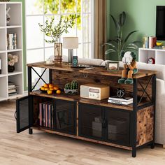 a living room filled with furniture and a wooden table topped with baskets next to a window