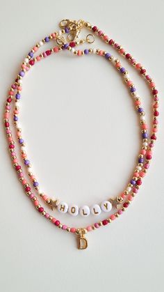 ❤️ PRODUCT DETAILS❤️ Adorn yourself in elegance with our customizable beaded necklace, featuring a vibrant mix of pink and purple beads complemented by intricate gold-plated bead details. Elevate your style or surprise a loved one with this personalized piece, designed to add a touch of sophistication to any outfit. Combination necklace in the photo:   https://www.etsy.com/listing/1539578875/custom-gold-initial-charm-necklace?click_key=9ca908a147b6ac2b551227783c627cbedee0759a%3A1539578875&click_sum=eb67b3b5&ref=shop_home_active_21&pro=1 ❤️ CARE ❤️ ❤️ Keep jewelry dry and avoid contact with water, lotions, etc ❤️ SIZE❤️ If you want a different length, write the size in the message to seller box when you check out.  Lenght: 15-16 inch/38-41 cm. ❤️ PACKAGING ❤️ ❤️ Each order comes with a love Beaded Initial Necklace, Purple Beaded Necklace With Letter Beads As Gift, Personalized Pink Round Beads, Pink Letter Beads Necklace For Jewelry Making, Pink Necklace For Jewelry Making With Letter Beads, Personalized Pink Round Bead Necklaces, Pink Gold Beads For Jewelry Making, Pink Beaded Necklace With Gold Beads As Gift, Pink Beaded Necklace With Gold Beads For Gift