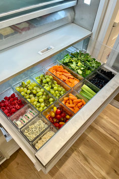 a display case filled with lots of different fruits and vegetables