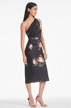 The Carmen Dress - Noir Blossom is sure to make a lasting impression. Featuring a mid-length silhouette, one shoulder design, and a timeless floral print, the dress exudes elegance and sophistication. Constructed of a luxurious satin crepe, you're sure to feel your best for any occasion.The belt is not included. Details:Model is 5'10" wearing size 242" LongSide ZipperPrinted Satin Crepe100% PolyesterImportedStyle #F232D24-004 Silk Dress With Floral Print And Asymmetrical Neckline, Elegant Silk Floral Dress For Garden Party, Spring Midi-length One-shoulder Evening Dress, Fitted One Shoulder Dress With Ruched Bodice For Spring, Silk Floral Print Midi Dress For Evening, Elegant Silk Floral Dress For Spring, Spring Off-shoulder Silk Midi Dress, Spring Evening Midi Dress With Asymmetrical Neckline, Off-shoulder Silk Midi Dress For Spring