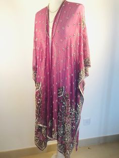 "A Unique and Truly Beautiful Kimono Jacket. This has been Handmade from a Vintage Indian Silk Sari.... so is completely Original and one of a kind. A Wonderfully Chic, flattering colour way of Dusky Lilac,Embellished with allover Beads and Sequins that Sparkle and catch the Light. The Gorgeous embroidery design has 1000's of Silver bugle beads , Pearly white beads and Glittering Crystals. This Stunning 3/4 length Jacket is made in Silk Chiffon ,so drapes elegantly ,with loose Waterfall sleeves Traditional Sequined Kaftan With Drape, Traditional Sequined Kaftan With Traditional Drape, Party Kaftan With Sequins In Traditional Drape, Bollywood Sequin Kaftan For Festivals, Pink Kaftan With Mirror Work For Wedding, Party Pink Kaftan With Mirror Work, Pink Mirror Work Kaftan For Party, Pink Mirror Work Party Kaftan, Festive Silk Purple Kaftan