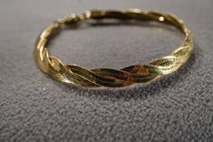 I am offering this fabulous vintage yellow gold tone bracelet. This piece is truly gorgeous, and it has the following features: * beautiful vintage bracelet * woven * twisted * lobster claw closure * 7 inches in length This is a fantastic and classic piece. There is tons of sparkle and shine with this piece. It will beautifully complement your upcoming fashion season. Buyer pays all shipping and handling. Claw Bracelet, Stud Style, Vintage Bracelet, Brooch Jewelry, Rhinestone Studs, Vintage Victorian, Genuine Turquoise, Fashion Seasons, Braided Bracelets