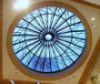 the inside of a building with a large glass dome in it's center window