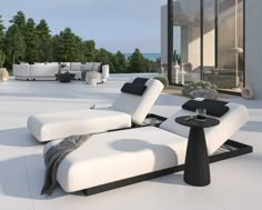 an outdoor lounge area with white and black furniture