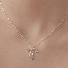 Sterling Silver Bow Necklace, Sparkling Crystal Bow Charm Necklace, Bow Jewelry, Silver Necklace, Perfect Gift for Her (NZ2182) ▶ Product Info. - Material: 925 Sterling Silver / Cubic Zirconia - Metal Finish: 14K Gold / Silver + Anti-Tarnish E-Coat  - Safety: Nickle & Lead free and Hypoallergenic - Dimensions: Pendant - 17.4mm x 21mm w/width 3.2mm / Cubic Zirconia - 3.5mm - Length: 40cm + 3.5cm (length adjustable) - Weight: 3g - TATIANA & Silver 925 engraved tag was added. - Made In South Korea Minimal Silver Necklace, Girly Jewelry Silver, Silver Necklace Party Gift, Silver Necklace For Party Or As A Gift, Silver Necklace For Party Or Gift, Silver Necklace For Party And Gift, Elegant Silver Charm Necklaces, Elegant Sterling Silver Necklaces For Gifts, Elegant Round Pendant Necklaces As Gift