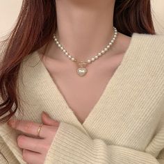 ✦ A must-have accessory for any fashionista, the Mermaid Pearl Beaded hEART cHARM Necklace is sure to add some sparkle and sophistication to your look. With its dainty and special design, this stunning piece will make a statement wherever you go. Get ready to turn heads and make hearts skip a beat when you wear this beautiful necklace! Luxurious, elegant, and timeless! ----------- DESCRIPTIONS ------------ Size (Length): 39.5cm- Color: White, Gold- Materials: Alloy, Mermaid Pearl, Rhinestone- SK Elegant Heart Choker Necklace For Valentine's Day, Elegant Heart Shaped Choker Necklace For Valentine's Day, Trendy Necklaces For Wedding And Valentine's Day, Trendy Wedding Necklaces For Valentine's Day, Party Beaded Necklaces With Heart Beads, Valentine's Day Party Pearl Necklace, Elegant Heart Beads Choker Necklace, Elegant Heart Beads Choker, Elegant Pearl Necklace With Heart Beads For Party