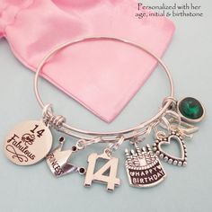 "14th Birthday Charm Bracelet, comes with all charms shown. You select which birthstone and initial you need. All of our jewelry comes beautifully and uniquely packagedready for gift-giving. We can also include a personal note The bangle is adjustable to fit most wrist sizes and is made of jewelry grade stainless steel. Stainless steel bracelets are always our choice for expandable bracelets. Stainless steel ensures your bracelet will never tarnish or lose it's color - it's also easy to care for Birthday Round Charm Bracelet, Adjustable Charm Bracelet For Birthdays, Adjustable Round Charm Bracelet For Birthday, Handmade Round Charm Bracelet For Birthday, Charm Bracelet For Birthday And Valentine's Day, Adjustable Charm Bracelet For Birthday Valentine's Day, Adjustable Charm Bracelet For Birthday And Valentine's Day, Round Charm Bracelet For Birthday And Valentine's Day, Personalized Charm Bracelet For Birthday And Valentine's Day