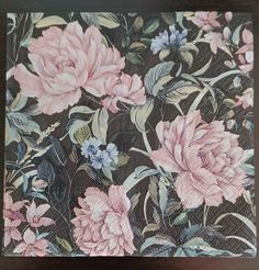 a close up of a piece of cloth with pink flowers on it and green leaves