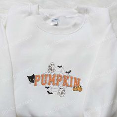 a white sweatshirt with the word pumpkin printed on it