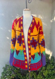 "Vintage boho crochet cardigan bold colors S/M hand knit. Very good condition. No label.  Possibly acrylic cotton yarn. Shoulders 18\" Sleeves 22\" Bust 38\" Waist 36\" Hips 46\" Length 31\"" Fitted Multicolor Cotton Cardigan, Multicolor Bohemian Knit Sweater, Bohemian Crochet Cotton Cardigan, Bohemian Cotton Crochet Cardigan, Fitted Multicolor Knitted Sweater, Yellow Bohemian Knit Sweater, Bohemian Yellow Sweater For Fall, Yellow Bohemian Sweater For Fall, Bohemian Knitted Cotton Cardigan