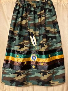 This is a Women's Ribbon Skirt. Camo with Air Force Veteran Patch,  5 gold stars and a feather appliqué. Elastic waist fits 38 to 44 inches includes 2 pockets. Length 36 inches. Homemade of 100% Cotton fabric in South Dakota. #004 Fancy Shawl Regalia Pattern, Fancy Shawl Regalia, Ribbon Dresses, Native American Dress, Ribbon Skirt, American Dress, Air Force Veteran, Ribbon Skirts, Ribbon Dress