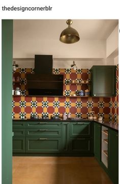 a kitchen with green cabinets and tiled backsplash