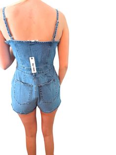 Cami denim romper with button front and pocket. Chic Medium Wash Cotton Denim Jumpsuit, Trendy Relaxed Fit Denim Jumpsuit For Day Out, Medium Wash Cotton Denim Jumpsuit For Day Out, Spring Shortalls Overall For Day Out, Spring Shortalls For Day Out, Chic Medium Wash Jumpsuits And Rompers With Pockets, Chic Light Wash Cotton Jumpsuits And Rompers, Spring Cotton Shortalls With Button Closure, Chic Dark Wash Overall Jumpsuits And Rompers