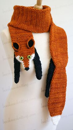 a knitted scarf with a fox head on it