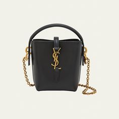 Saint Laurent "Le 37" bucket bag in calfskin leather  Top handle  Detachable chain crossbody strap, 19.2"L Can be worn as a top handle or crossbody bag  Open top with center YSL logo strap  Golden hardware  Approx. 5.3"H x 4.3"W x 1.9"D Made in Italy Virgo Rising, Dream Bags, Ysl Logo, 2024 Style, Leather Bucket Bag, Leather Bucket, Black Crossbody, Girl Gang, Open Top