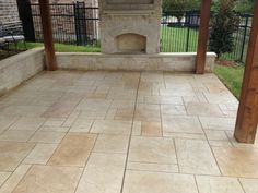 an outdoor fireplace in the middle of a patio