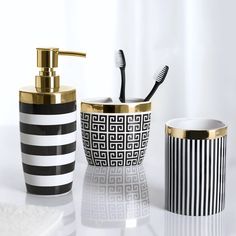 three bathroom accessories including toothbrushes, soap dispenser and brush holder