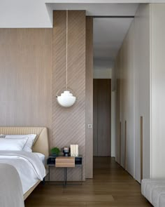 a bed sitting next to a wooden wall in a bedroom