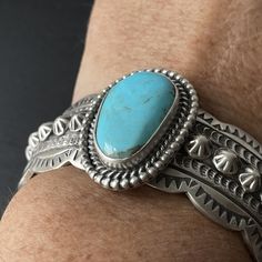 This stunning sterling silver heavy weight ocean blue Kingman turquoise cuff is made by a Navajo artist Wydell Billie and is hallmarked with his stamp. The inside measures 5.5" and the gap measures 1 3/8". Because of the weight of the bracelet it can not be adjusted. It is ideal for a 6.75-7" wrist at the current size. The widest spot at the stone measures 1.25". Turquoise Concho Cuff Bracelet Gift, Western Style Blue Sterling Silver Bracelet Gift, Western Turquoise Stamped Cuff Bracelet, Western Style Stamped Turquoise Cuff Bracelet, Turquoise Stamped Western Cuff Bracelet, Turquoise Western Stamped Cuff Bracelet, Southwestern Sterling Silver Cuff Bracelet In Blue, Southwestern Blue Concho Bracelets, Southwestern Turquoise Cuff Bracelet Stamped 925