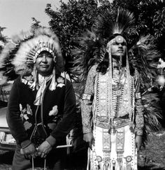 two native american men standing next to each other