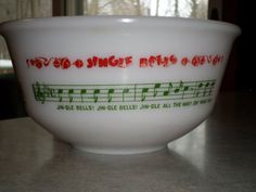 a white bowl sitting on top of a counter with music notes painted on the side